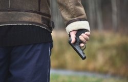 A hand holding a gun. 