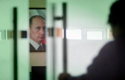 Image of Vladimir Putin behind closing door