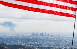 Flag over American city with pollution
